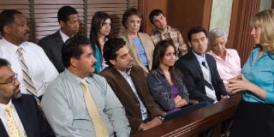 A group of people sitting in front of a wooden table.